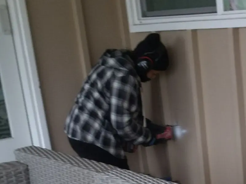 Professional electrician installing an exterior outlet in Alpine
